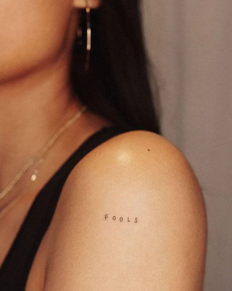 A “fools” tattoo on the shoulder