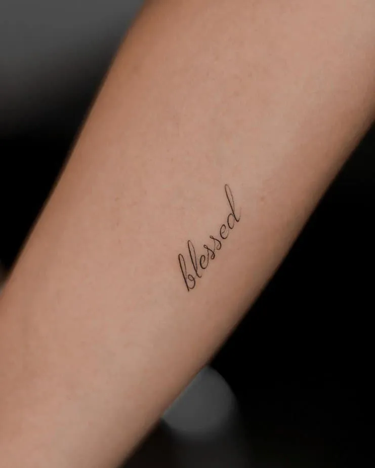  “blessed” tattoo on the arm